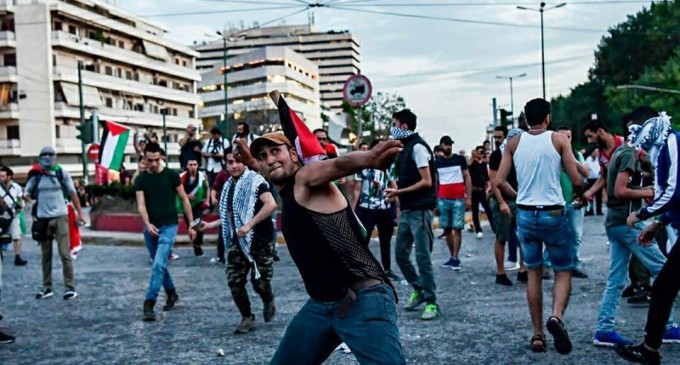 Les  Grecs qui lancent des pierres vers l’ambassade d’Israël en Grèce pour protester contre le massacre israélien contre les palestiniens dans la bande de Gaza