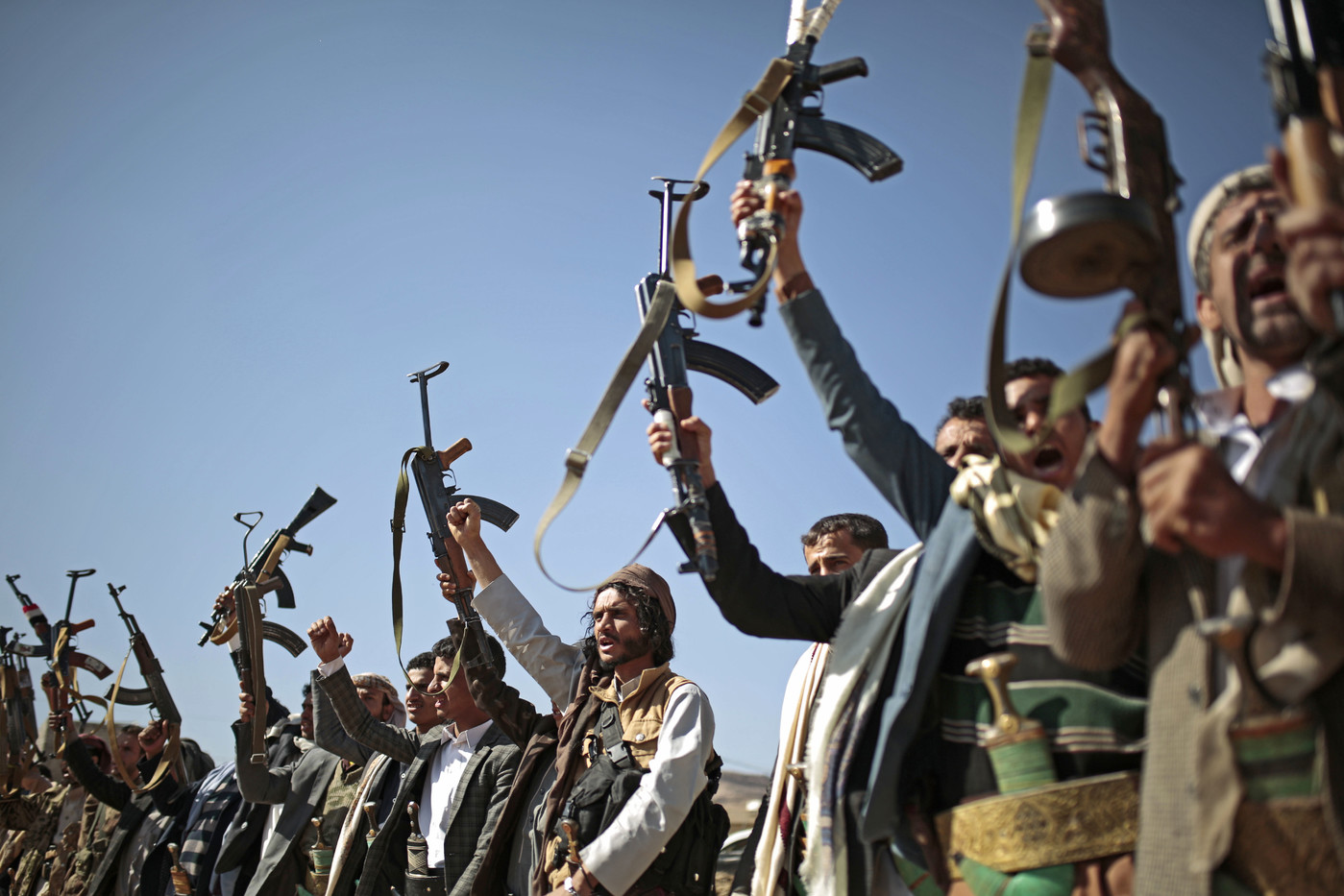 Tribesmen loyal to Houthi rebels hold up their weapons as they attend a gathering to show their support for the ongoing peace talks being held in Sweden, in Sanaa, Yemen, Thursday, Dec. 13, 2018. (AP Photo/Hani Mohammed)